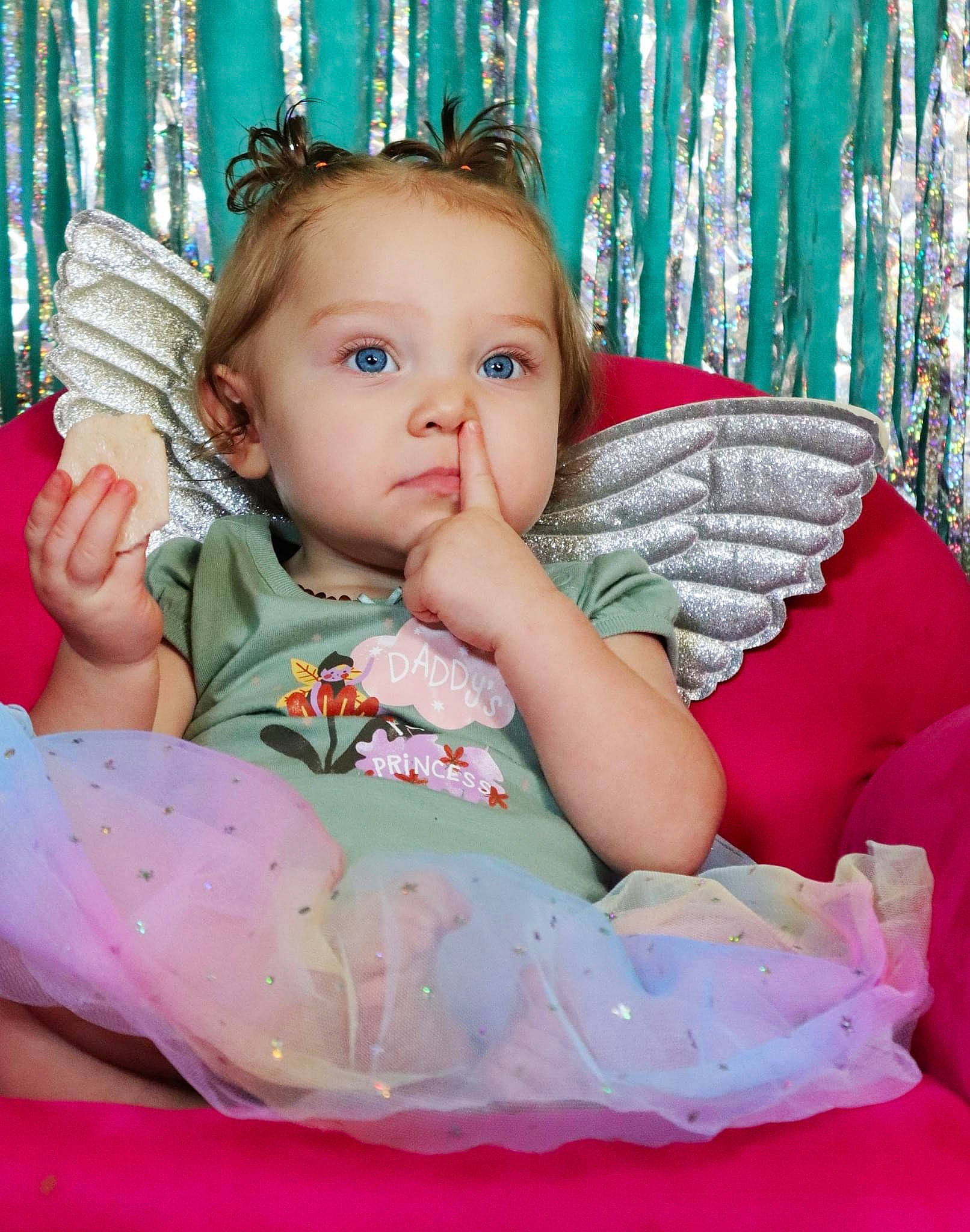 Chloe is registered to the contest to win money with this photo: baby, baby_products, baby_toddler_clothing, cheek, child, comfort, curtain, eye, fun, happy, head, human_body, iris, pattern, person, pink, sitting, skin, sleeve, textile