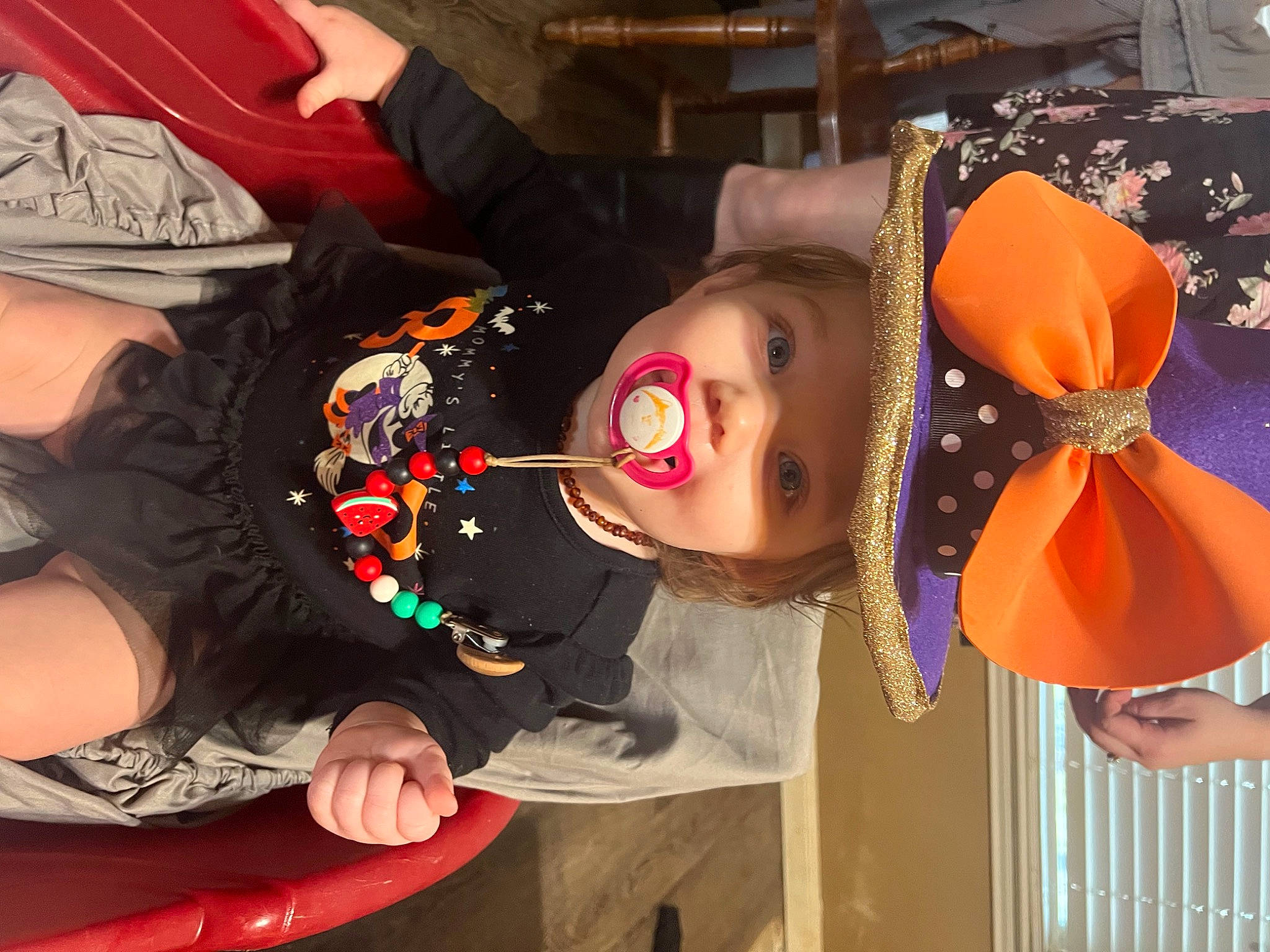 Chloe is registered to the contest to win money with this photo: child, costume, costume_hat, event, fashion_accessory, fun, hat, headwear, orange, party, party_supply, person, room