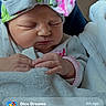 Sophia is registered to the contest to win money with this photo: baby, blanket, bow, child, cozy, cute, face, hands, headband, indoors, infant, mobile_screen, newborn, peaceful, person, portrait, skin, sleeping, soft, wrapped
