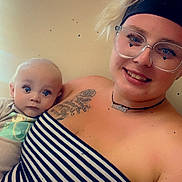 Daxx joined the competition — help win amazing prizes! baby, woman, glasses, headband, striped_clothing, tattoo, necklace, smile, indoor, portrait, person, child, holding, face, skin, young, casual, light, happy, background