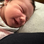 Mialynn is registered to the contest to win money with this photo: newborn, baby, smiling, close_up, face, sleeping, infant, soft, blanket, cute, peaceful, skin, portrait, child, head, lying_down, indoors, cozy, young, resting