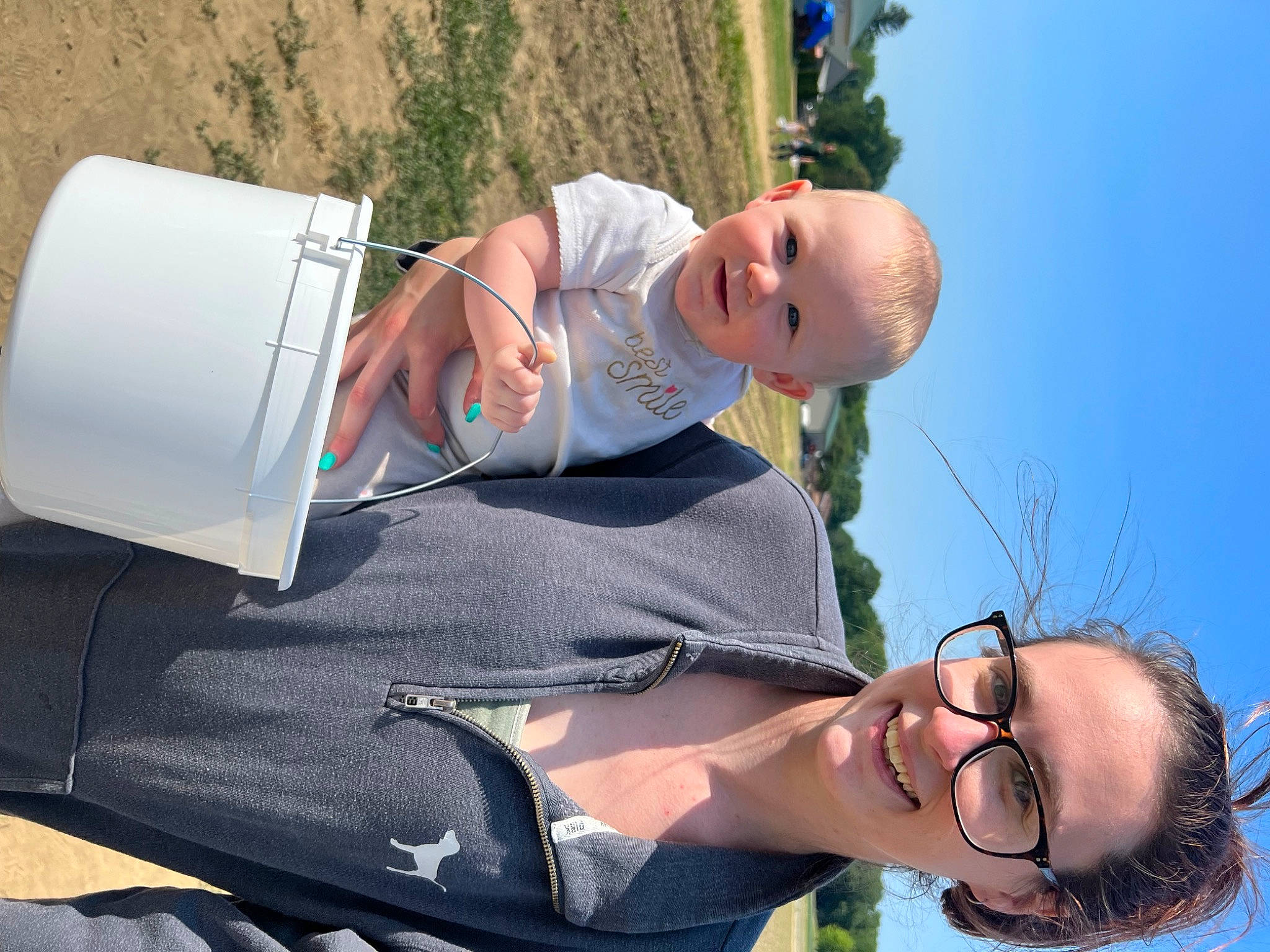Lauryn is registered to the contest to win money with this photo: baby, blue, eyewear, fun, gesture, glasses, grass, happy, hat, joy, leisure, mammal, natural_environment, people_in_nature, person, plant, recreation, sky, smile, toddler