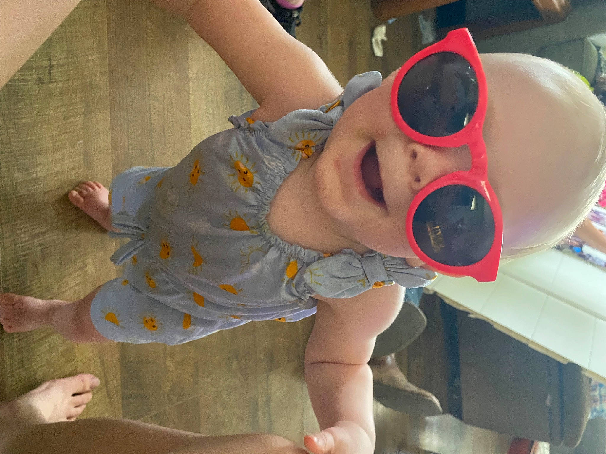 Lauryn is registered to the contest to win money with this photo: baby_toddler_clothing, child, elbow, eyewear, foot, fun, glasses, goggles, human_leg, knee, leg, leisure, mouth, person, personal_protective_equipment, pink, skin, sunglasses, thigh, toddler