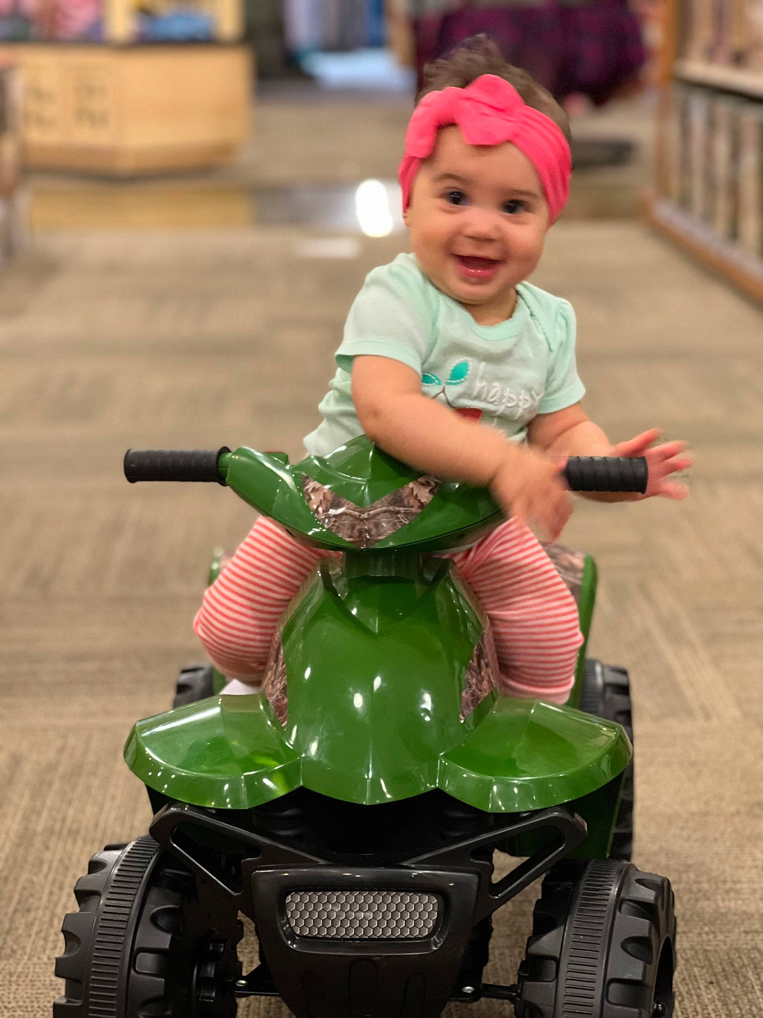 Maya joined the competition — help win amazing prizes! automotive_design, automotive_tire, automotive_wheel_system, baby, bumper, fun, green, hat, headwear, joy, mode_of_transport, motor_vehicle, person, photograph, riding_toy, smile, tire, toddler, toy, vehicle