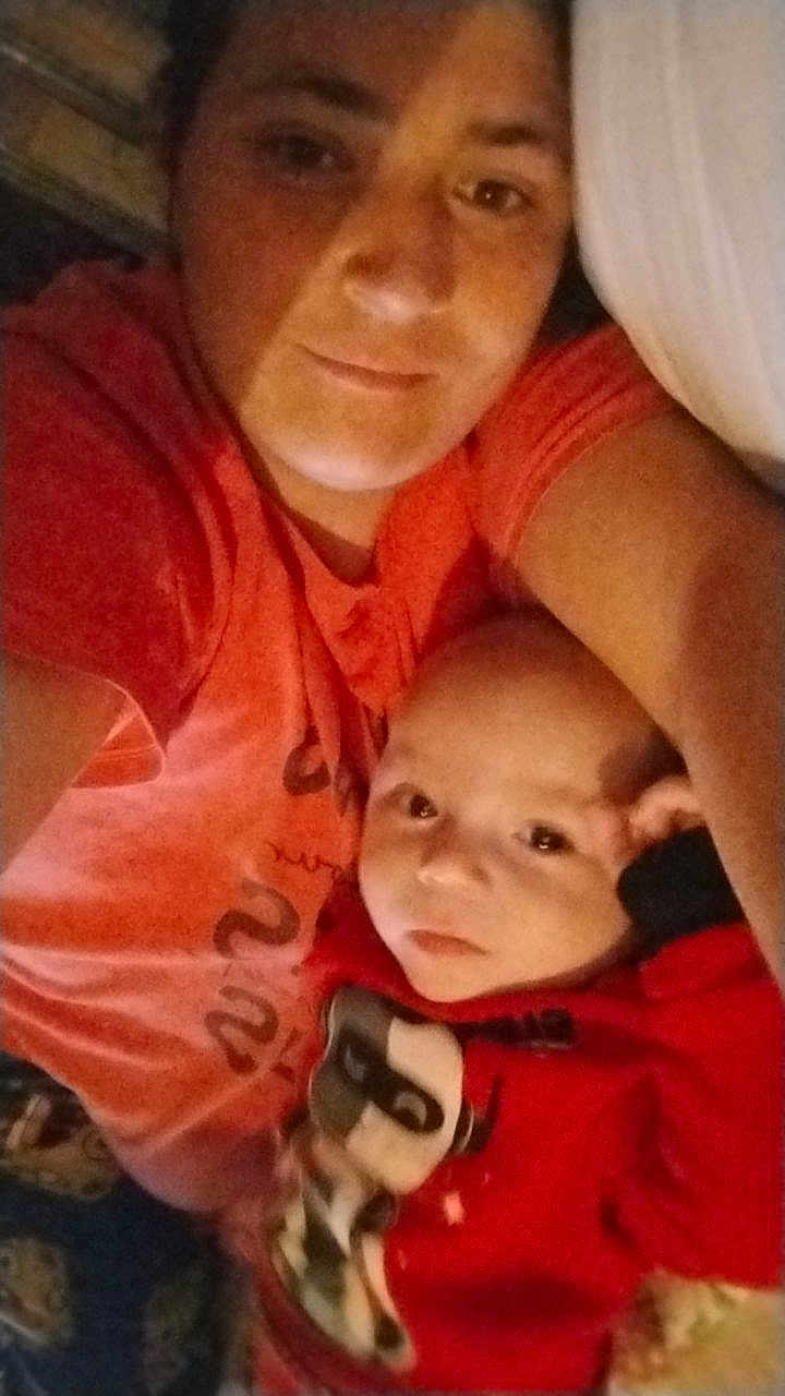 Walker joined the competition — help win amazing prizes! adult, baby, child, closeup, cozy, cuddle, family, face, indoor, intimate, person, portrait, red_clothing, sleepwear, smile, snuggle, soft_lighting, togetherness, warmth, young_child