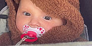 Amina participe au concours pour gagner de l'argent avec cette photo : adorable, baby, baby_accessory, blanket, child, closeup, cute, expression, eyes, face, fuzzy_clothing, hoodie, indoors, infant, pacifier, person, portrait, reindeer_costume, soft_texture, warm_clothing