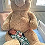 Elyo participe au concours pour gagner de l'argent avec cette photo : newborn, baby, teddy_bear, plush, bed, window, striped_clothing, infant, cute, soft_toy, sleepwear, indoors, child, cozy, furniture, resting, comfort, homedecor, light, person