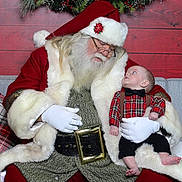 Waylon Hood is registered to the contest to win money with this photo: santa_claus, baby, christmas, holiday, plaid_shirt, bow_tie, red_suit, white_fur, wreath, berries, glasses, gloves, beard, couch, festive, indoor, decorations, child, adult, portrait