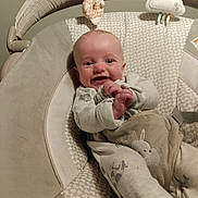 Waylon Hood is registered to the contest to win money with this photo: baby, smiling, infant, pajamas, baby_seat, toy, plush_toy, bunny, clothing, happy, child, indoor, face, person, cushion, comfort, cute, small_child, hands, seated