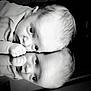 baby, infant, reflection, black_and_white, face, hand, closeup, portrait, cute, child, skin, young, mirror, expression, resting, lying_down, soft_light, monochrome, curious, peaceful