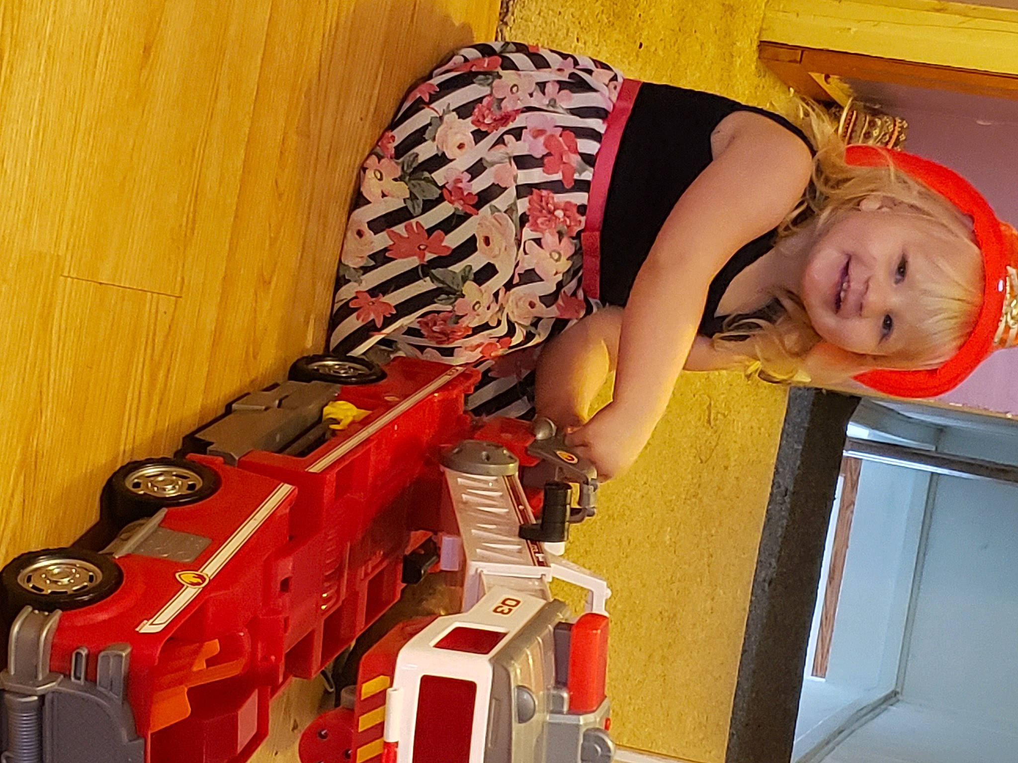 Kiley Godfrey is registered to the contest to win money with this photo: carton, child, dress, eye, flooring, fun, glasses, hat, head, human_leg, joy, magenta, orange, person, room, smile, t_shirt, thigh, toddler, waist