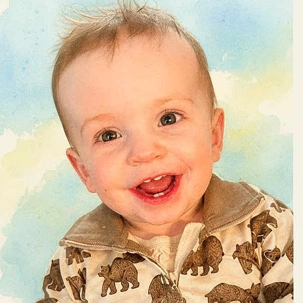 Owen is registered to the contest to win money with this photo: baby, child, smiling, face, jacket, bear_print, happy, cute, portrait, young_child, light_background, expression, teeth, eyes, hair, clothing, infant, closeup, warm, adorable