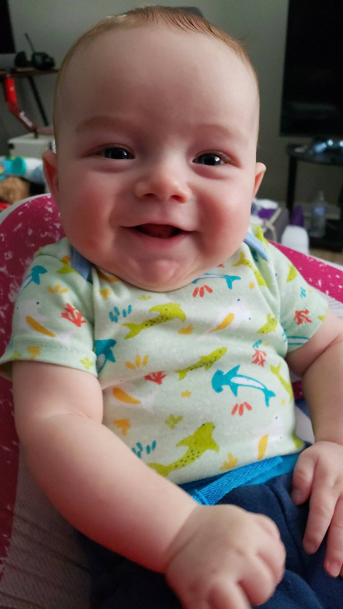 Bearet is registered to the contest to win money with this photo: baby, baby_toddler_clothing, cheek, child, chin, comfort, eye, fun, happy, iris, joy, mouth, nose, person, pink, product, sitting, skin, sleeve, smile