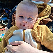 Declan joined the competition — help win amazing prizes! baby, child, person, smile, face, hand, fleece, jacket, yellow, white, zipper, outdoor, sunlight, adult, holding, warmth, portrait, closeup, cozy, happy