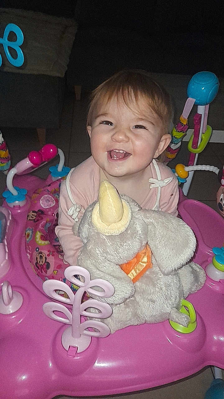 Inaya participe au concours pour gagner de l'argent avec cette photo : baby, smiling, child, stuffed_animal, toy, pink, activity_center, indoor, happy, face, playtime, infant, cute, young_child, furniture, seat, colorful, cheerful, clothing, home