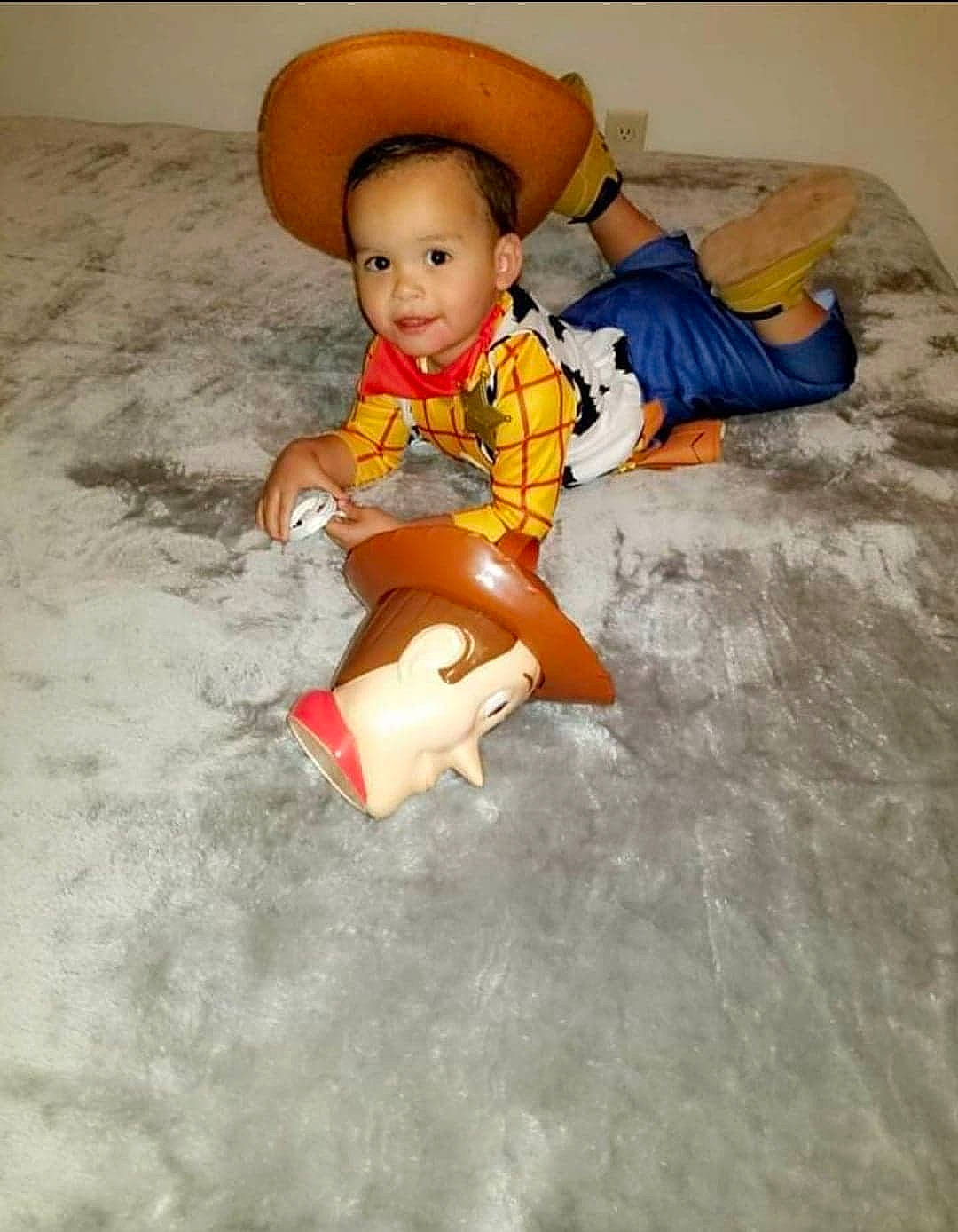 Emiliano is registered to the contest to win money with this photo: baby, child, doll, figurine, flooring, fun, hat, headgear, person, play, toddler, toy