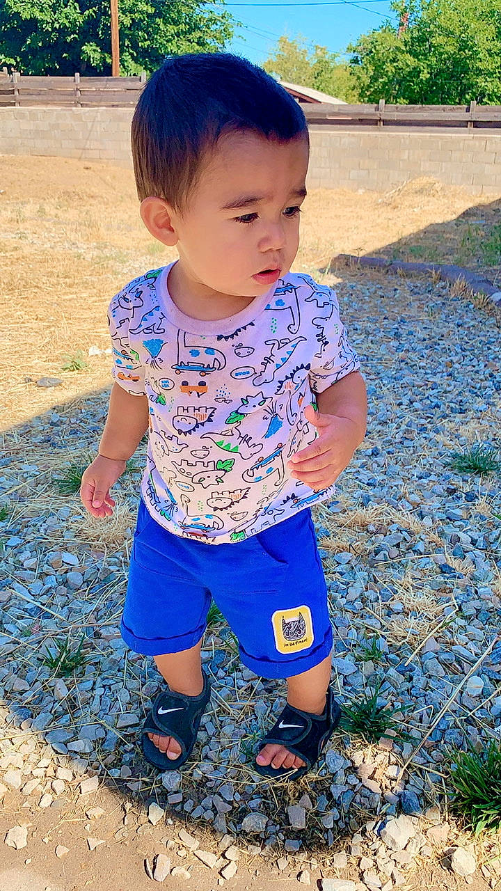 Ezio is registered to the contest to win money with this photo: baby_toddler_clothing, blue, child, grass, pattern, person, play, smile, summer, t_shirt, toddler