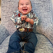 Akani is registered to the contest to win money with this photo: baby, child, smile, happy, jeans, shirt, belt, armchair, socks, indoor, portrait, cute, seated, infant, clothing, furniture, person, expression, joy, small