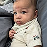 Colter is registered to the contest to win money with this photo: baby, infant, child, cute, shirt, car_print, eyes, face, expression, cushion, gray, soft, indoor, portrait, sitting, hand, clothing, young, person, toddler