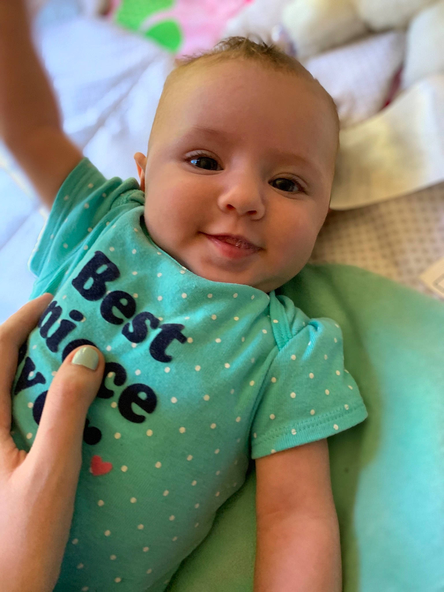 Sienna Joy is registered to the contest to win money with this photo: baby, baby_toddler_clothing, beauty, child, face, green, hand, head, neck, person, play, skin, smile, toddler