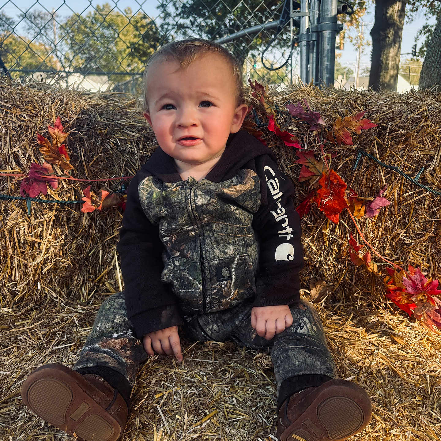 Grayson joined the competition — help win amazing prizes! baby, clothing, coat, countryside, face, footwear, grass, head, jacket, jeans, nature, outdoors, pants, person, photography, plant, portrait, shoe, soil, straw