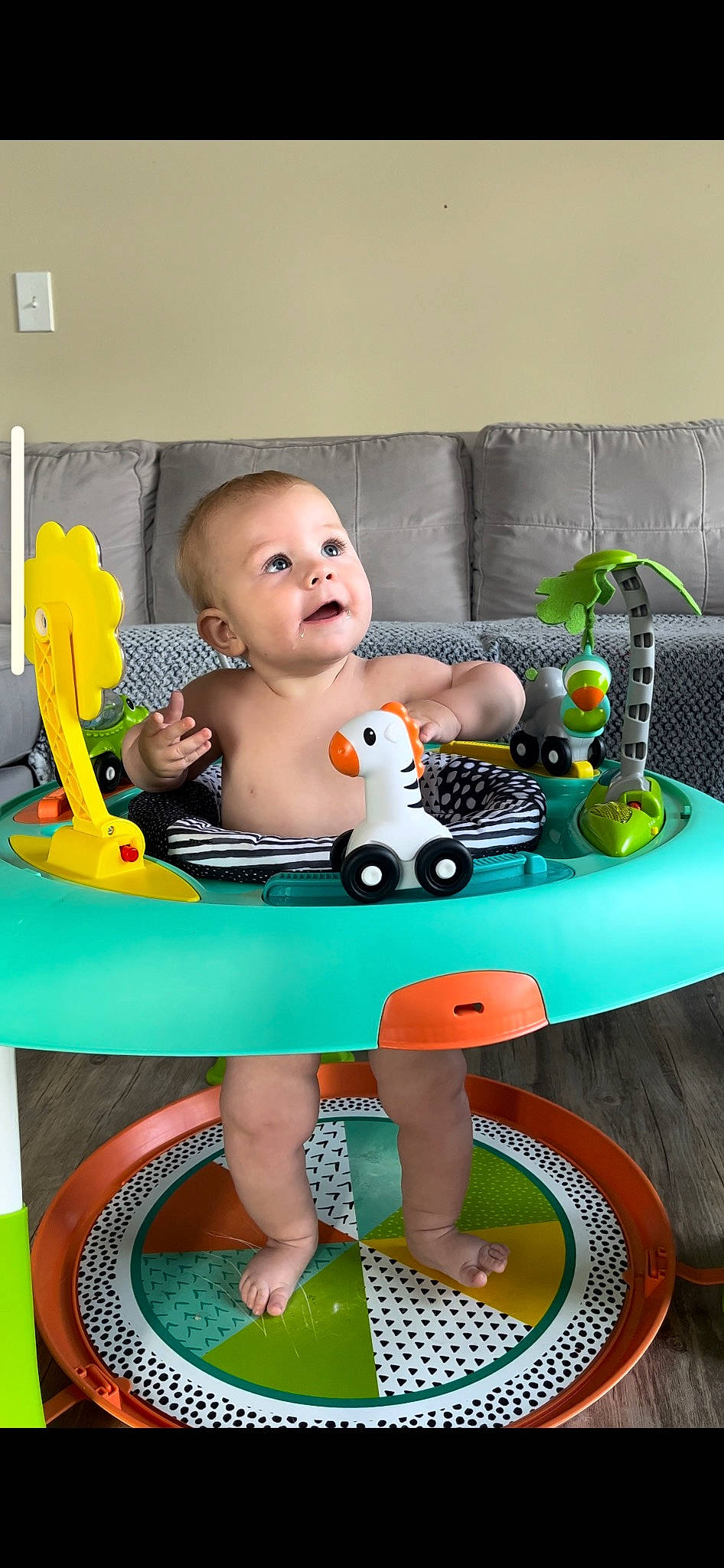 August is registered to the contest to win money with this photo: baby, baby_playing_with_toys, baby_products, baby_safety, baby_toddler_clothing, baby_toys, chair, child, fun, happy, leisure, person, plastic, play, room, sandal, sitting, thigh, toddler, toy
