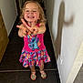 child, girl, smiling, happy, dress, pink, sandals, shadow, hallway, floor, tile, wall, indoor, person, playful, gesture, cute, hair, standing, footwear