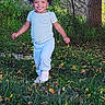 Nova Sage is registered to the contest to win money with this photo: child, toddler, smiling, happy, outdoor, grass, autumn, leaves, tree, nature, garden, fence, walking, standing, curly_hair, portrait, full_body, playful, clothing, daylight