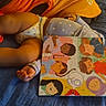 Nova Sage is registered to the contest to win money with this photo: baby, infant, child, lying_down, blue_quilt, orange_clothing, polka_dot, leggings, children_book, storybook, reading, bed, cozy, indoor, candid, hands, legs, curly_hair, colorful, portrait