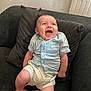 Ethan a rejoint le concours — aidez-le/la à gagner de superbes lots ! baby, child, smiling, happy, couch, pillow, clothing, shorts, shirt, indoor, person, footwear, skin, face, head, legs, sitting, comfort, radiant, joy