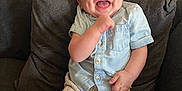 Ethan participe au concours pour gagner de l'argent avec cette photo : baby, smile, happy, child, couch, pillow, clothing, shorts, shirt, indoor, furniture, person, infant, sitting, joy, face, skin, leg, hand, radiator