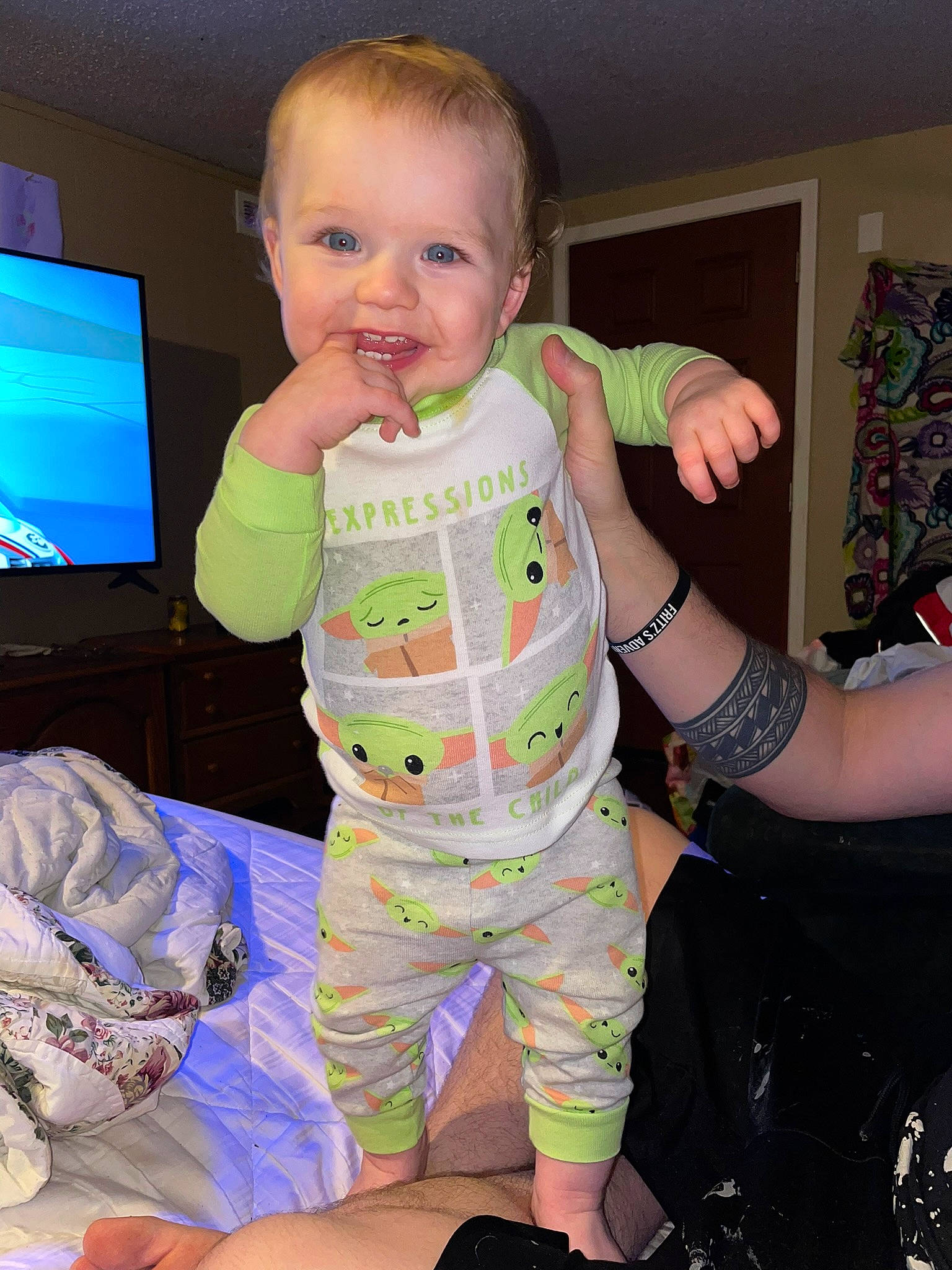 Damon is registered to the contest to win money with this photo: baby, baby_toddler_clothing, cheek, comfort, cool, facial_expression, finger, gesture, iris, joint, mouth, person, product, shoulder, skin, sleeve, smile, standing, television, thumb