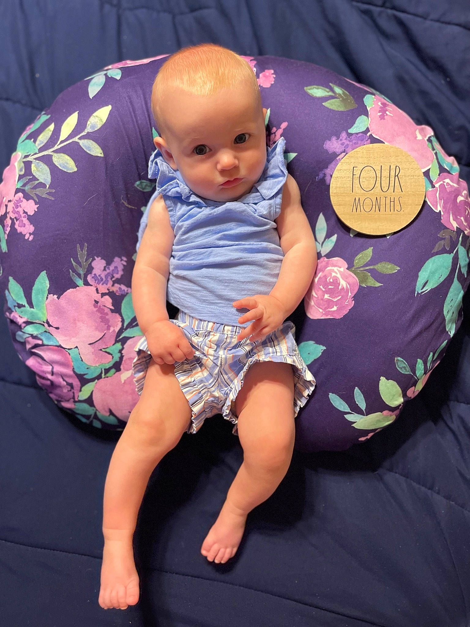 Haven is registered to the contest to win money with this photo: abdomen, arm, baby, baby_products, baby_toddler_clothing, chair, comfort, event, face, fashion_accessory, foot, human_body, human_leg, leg, pattern, person, pink, sitting, t_shirt, thigh
