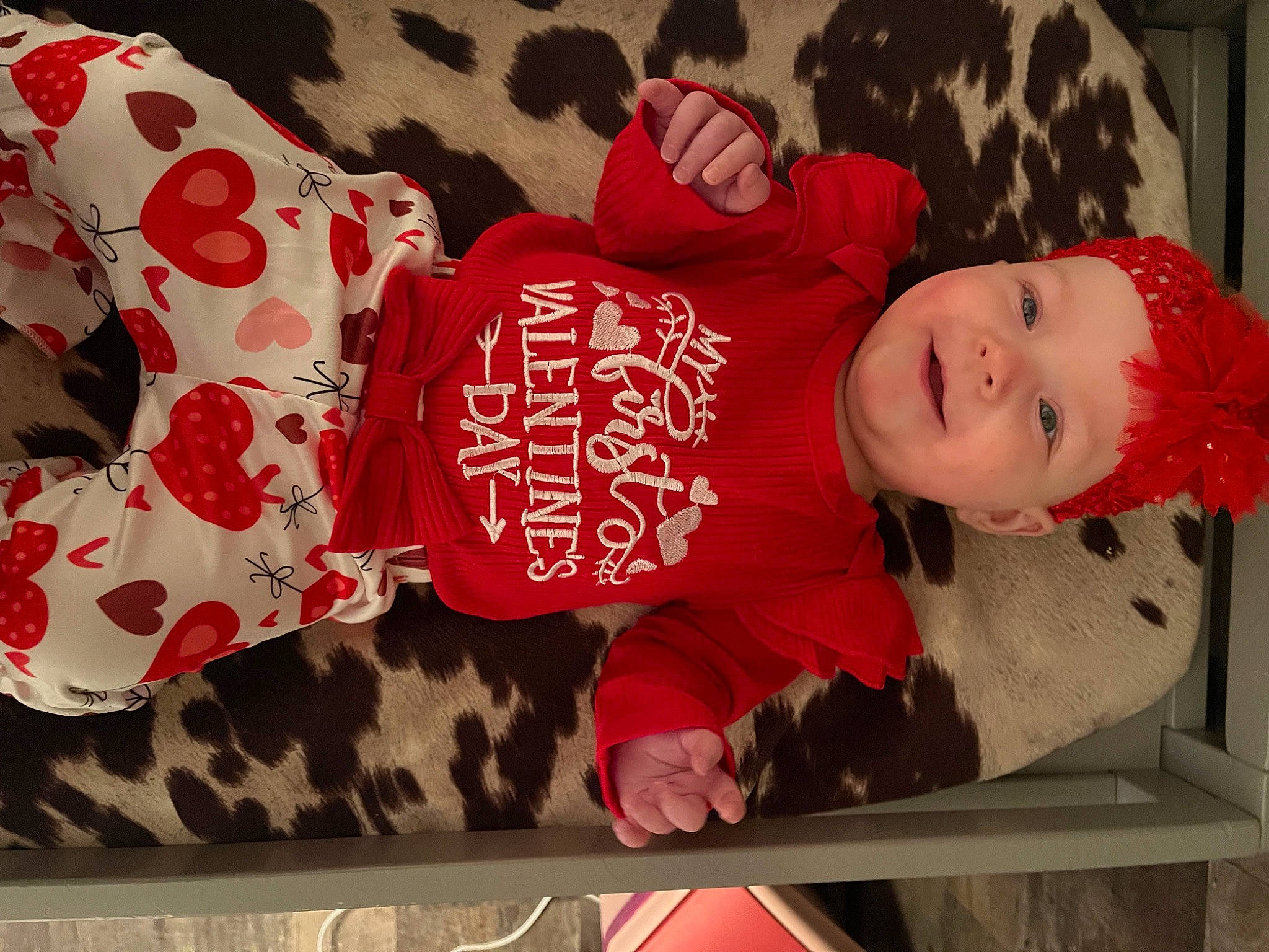 Braelynn is registered to the contest to win money with this photo: baby, baby_toddler_clothing, carmine, child, flooring, font, headwear, joy, linens, pattern, person, pink, product, red, room, skin, sleeve, smile, sock, textile