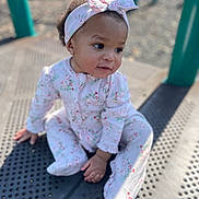 Treasure joined the competition — help win amazing prizes! baby, child, infant, headband, bow, onesie, floral_pattern, playground, outdoor, curious, sitting, cute, portrait, sunlight, daylight, skin, hand, footed_pajamas, expression, young