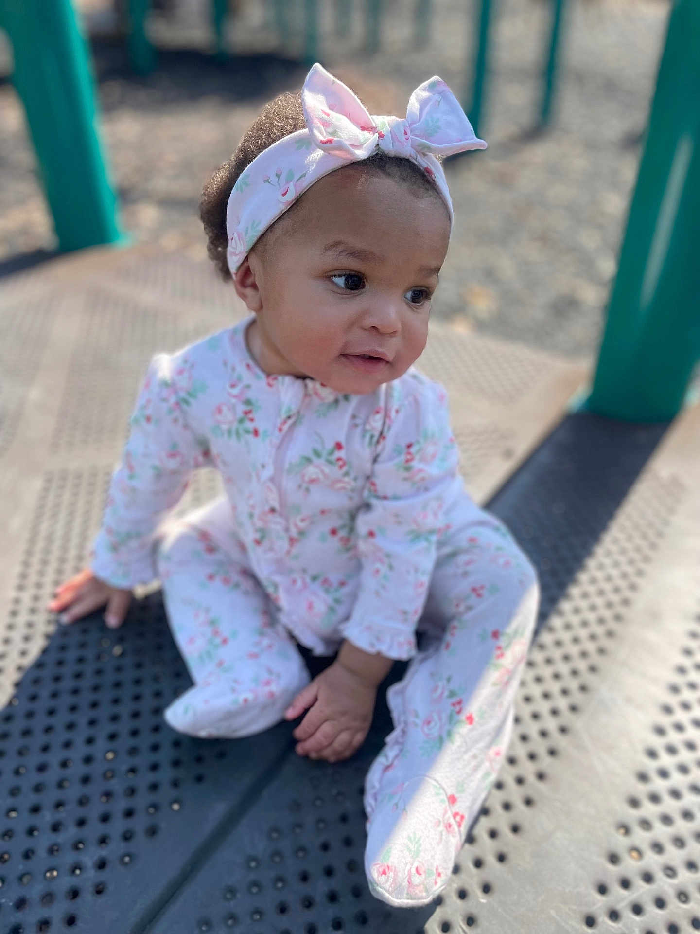 Treasure joined the competition — help win amazing prizes! baby, child, infant, headband, bow, onesie, floral_pattern, playground, outdoor, curious, sitting, cute, portrait, sunlight, daylight, skin, hand, footed_pajamas, expression, young