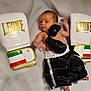 Mylan a rejoint le concours — aidez-le/la à gagner de superbes lots ! baby, baby_boy, black_gloves, boxing, boxing_gloves, boxing_shorts, clothing, cute, indoor, infant, leone_brand, lying_down, newborn, person, portrait, small_baby, soft_blanket, sport, tiny, white_gloves