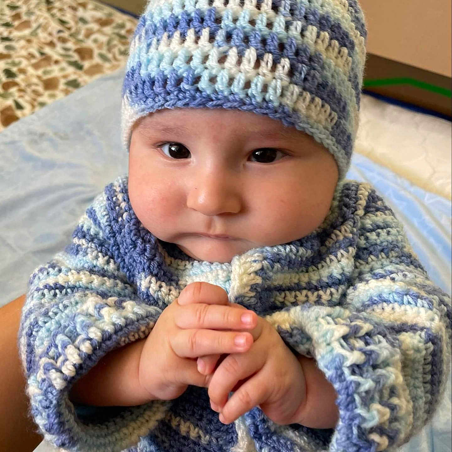 Evangelo joined the competition — help win amazing prizes! baby, blue, child, chubby_cheeks, clasped_hands, closeup, cozy, cute, expression, hands, indoor, infant, knit_hat, knit_sweater, person, portrait, soft_lighting, striped, warm, white