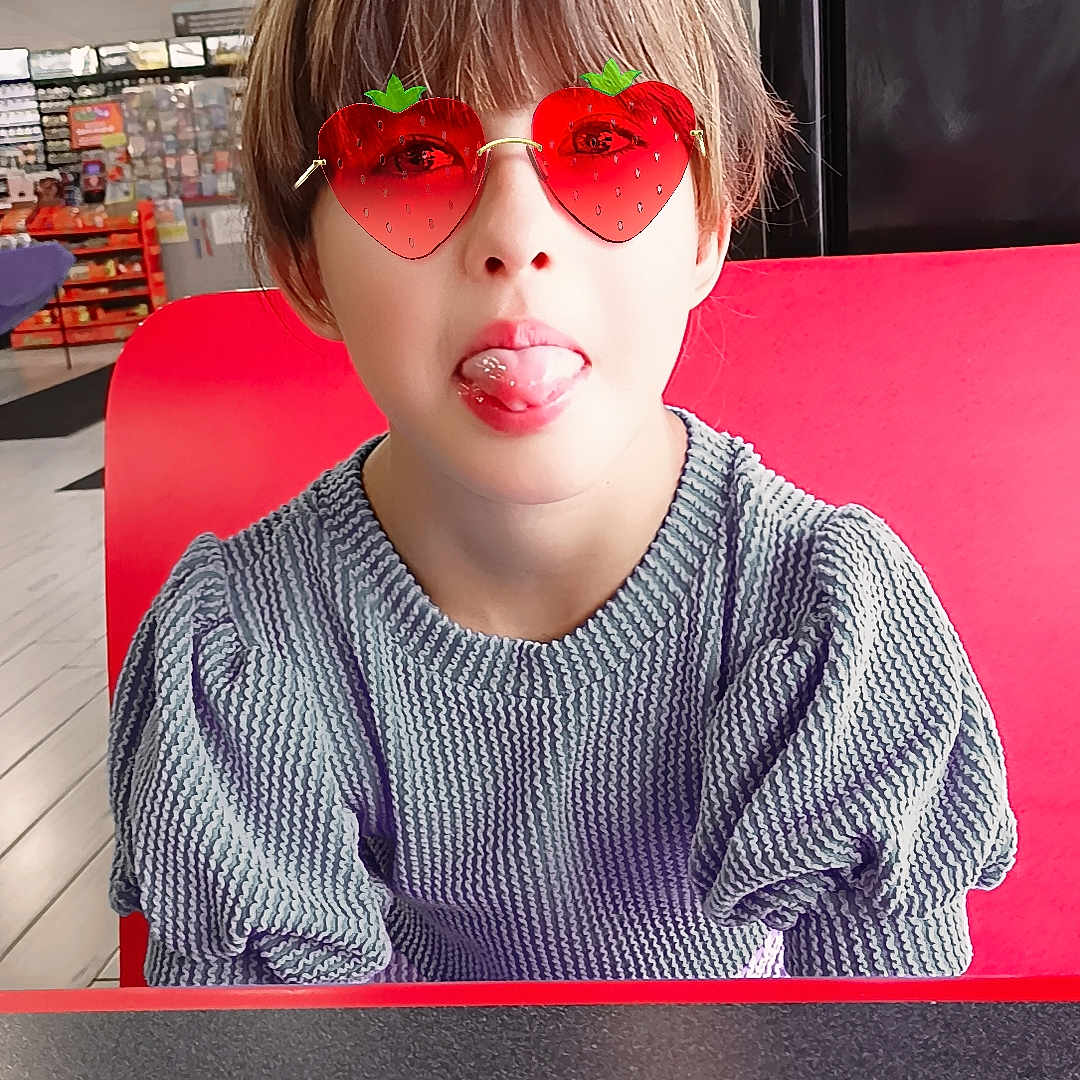 Izzy Nicole joined the competition — help win amazing prizes! casual, child, cute, fashion, funny_face, hair, indoor, light, person, playful, portrait, red, seat, smile, strawberry, sunglasses, sweater, table, tongue_out, young