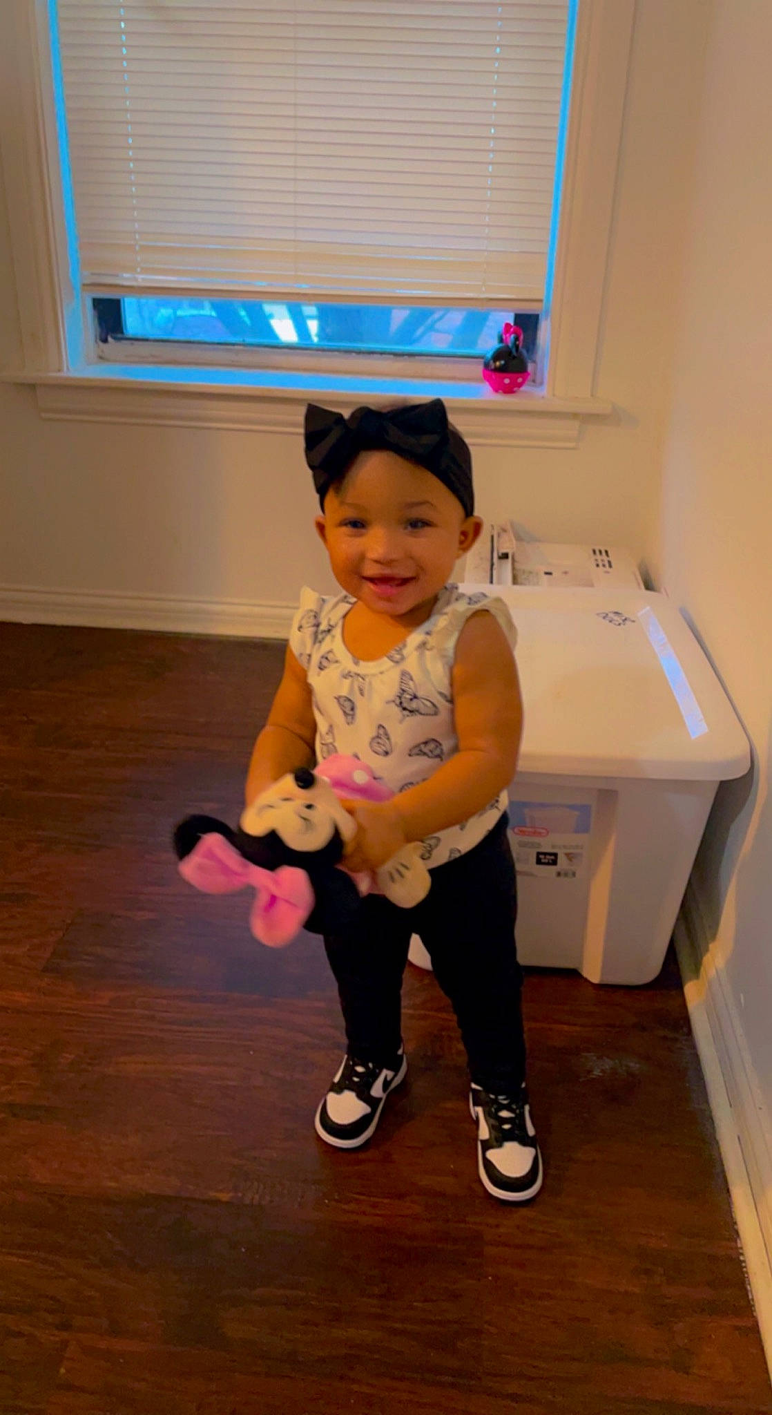 Jordyn is registered to the contest to win money with this photo: child, face, floor, flooring, fun, happy, headwear, human_leg, joy, knee, leg, magenta, person, sandal, shoe, sleeve, smile, sneakers, standing, t_shirt