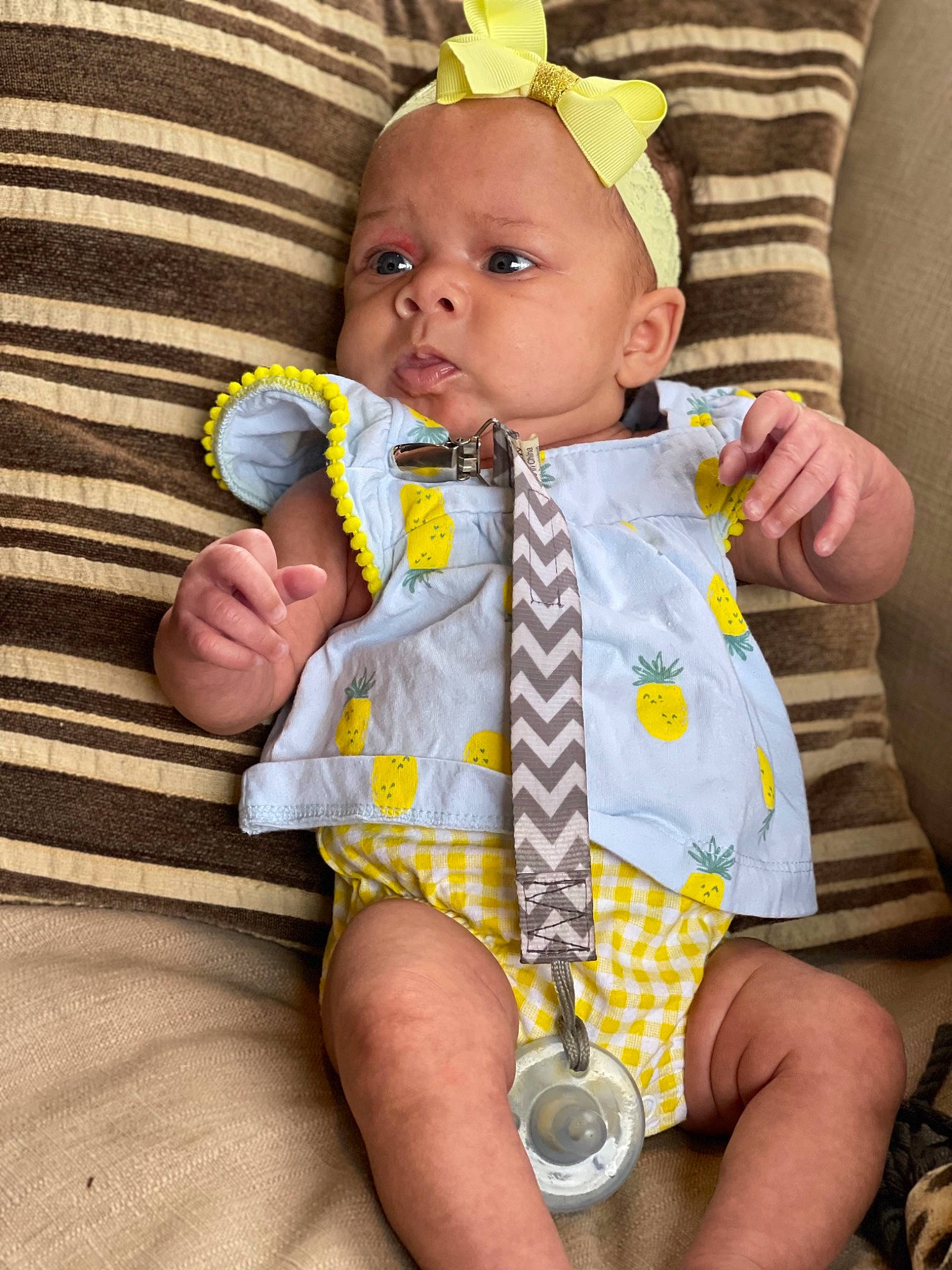 Kiara is registered to the contest to win money with this photo: baby, baby_toddler_clothing, cheek, child, comfort, face, finger, hand, happy, human_body, iris, linens, nail, pattern, person, sitting, skin, sleeve, thigh, thumb