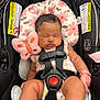 Naziyah is registered to the contest to win money with this photo: baby, car_seat, sleeping, infant, pink, plush_butterfly, mittens, diaper, safety_harness, head_support, floral_pattern, soft_toy, child, cute, resting, indoors, close_up, newborn, peaceful, comfortable