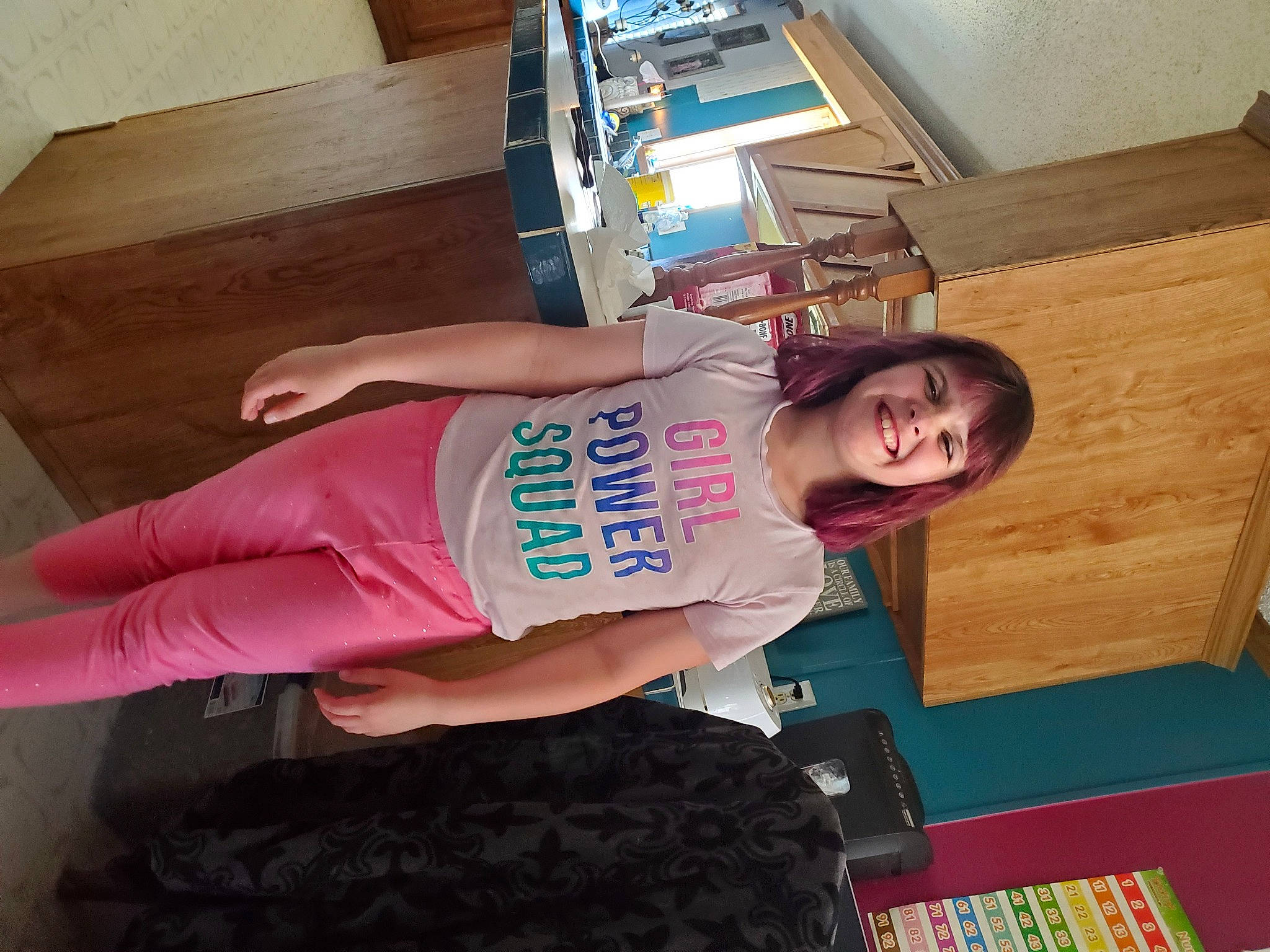 Leslie is registered to the contest to win money with this photo: elbow, floor, flooring, fun, hardwood, human_leg, joint, joy, knee, person, shorts, sleeve, sportswear, t_shirt, thigh, thumb, trunk, varnish, waist, wood