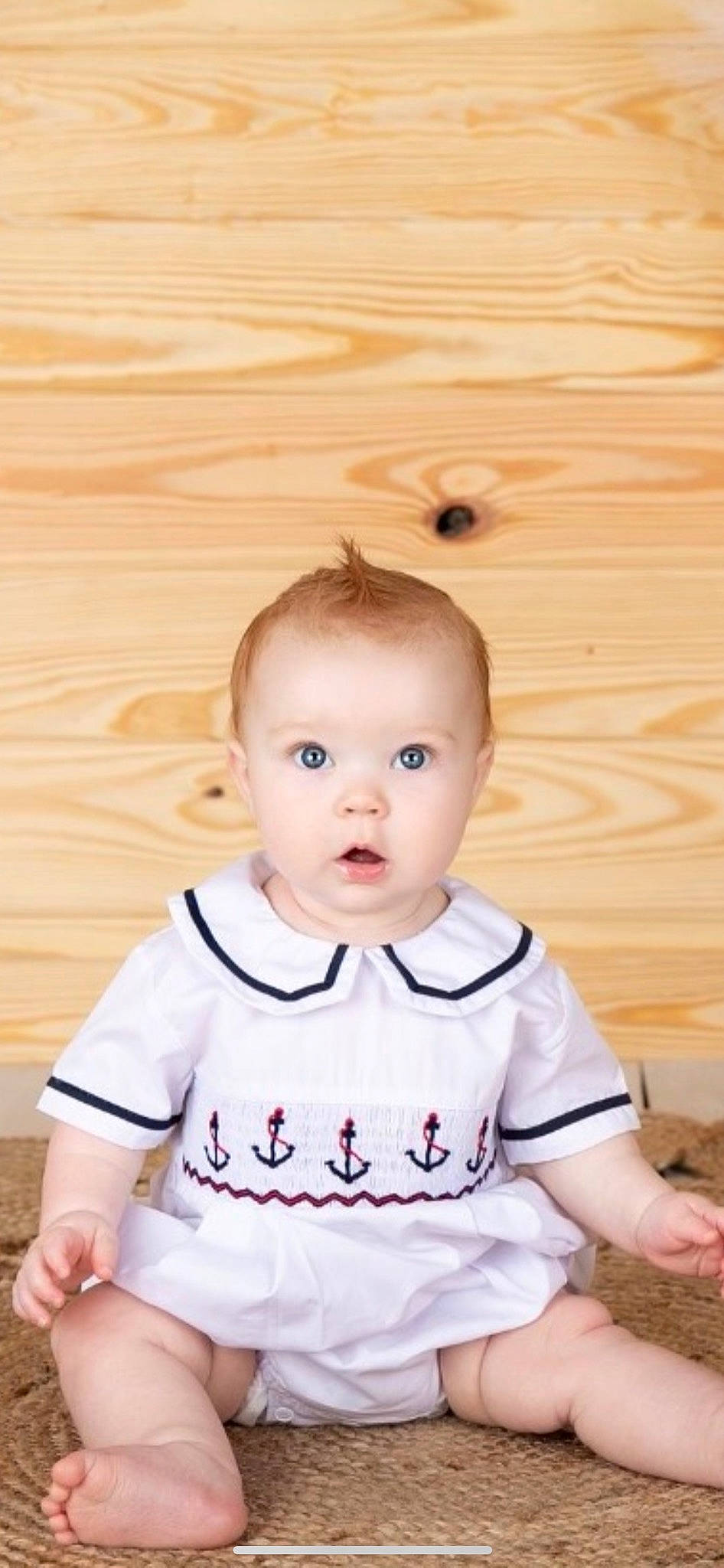 Sterling is registered to the contest to win money with this photo: baby, baby_toddler_clothing, cheek, child, collar, eye, flash_photography, flooring, happy, hardwood, human_body, iris, person, shoulder, sitting, skin, sleeve, surprise, t_shirt, toddler