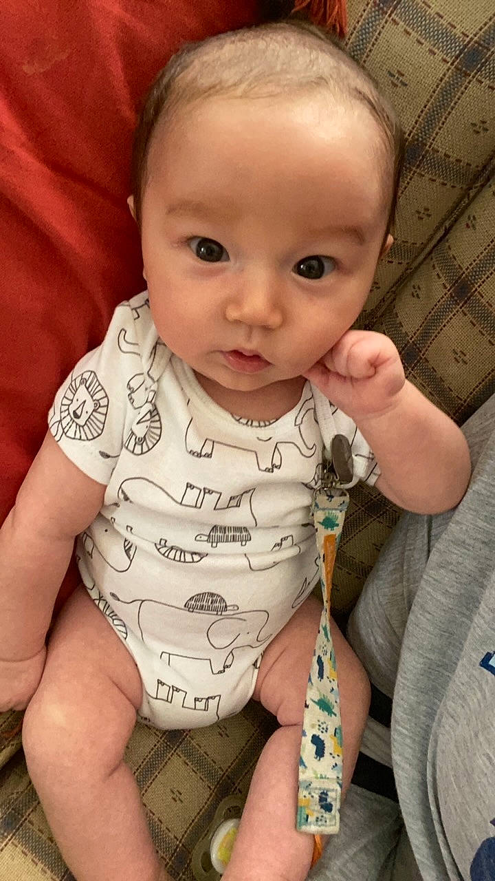 Ivan is registered to the contest to win money with this photo: arm, baby_toddler_clothing, cheek, chin, comfort, eye, eyebrow, facial_expression, finger, gesture, hand, head, iris, lip, mouth, neck, nose, person, product, skin