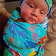 Jackson joined the competition — help win amazing prizes! newborn, baby, infant, child, face, portrait, sleepy, swaddled, swaddle, hat, cap, colorful, fish_pattern, ocean_theme, clothing, blanket, closeup, indoors, cuddled, photography