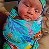 Jackson joined the competition — help win amazing prizes! baby, blanket, cap, child, closeup, clothing, colorful, cuddled, face, fish_pattern, hat, indoors, infant, newborn, ocean_theme, photography, portrait, sleepy, swaddle, swaddled