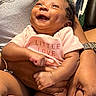 baby, smiling, infant, child, person, hands, arms, pink_clothing, cute, happy, portrait, closeup, skin, love, family, indoor, holding, newborn, toddler, expression