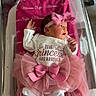 newborn, baby, infant, hospital, bassinet, pink, tutu, headband, blanket, clothing, person, cute, sleeping_baby, newborn_baby, hospital_room, portrait, baby_girl, text, hospital_card, pink_bow