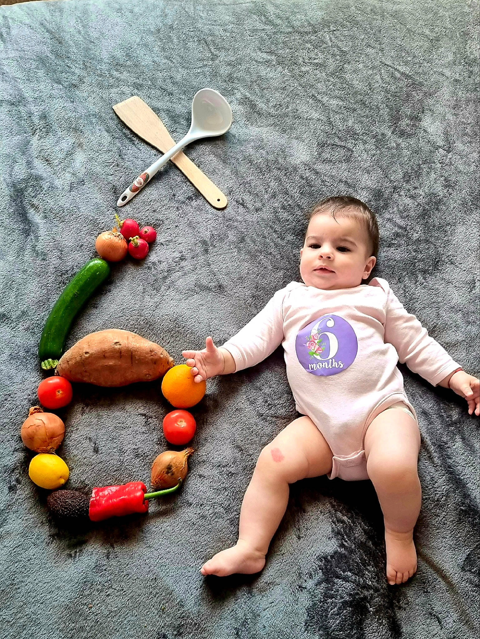 Mira is registered to the contest to win money with this photo: baby, baby_toddler_clothing, child, finger, foot, fruit, fun, happy, human_leg, leg, musical_instrument, natural_foods, person, plant, play, sitting, stuffed_toy, thigh, toddler, toy